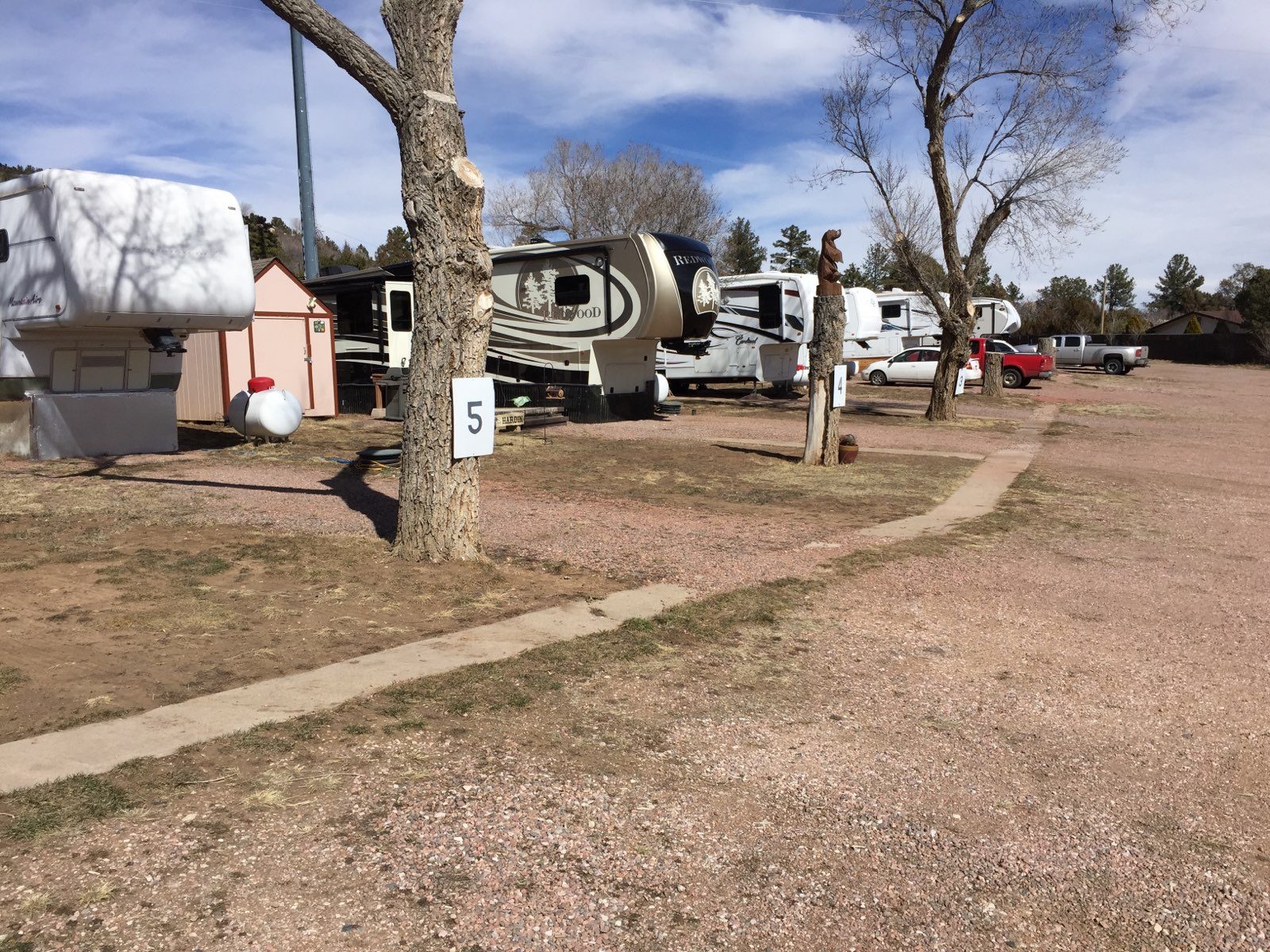 Numbered RV sites with fifth wheels settled in along the park road at Sunview RV Park