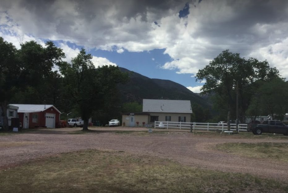 Park grounds, office, and red barn beneath the mountain at Sunview RV Park